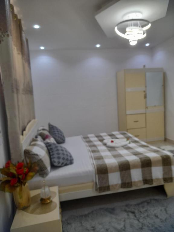 a bedroom with a bed with a checkered blanket at JP Immo in Dakar