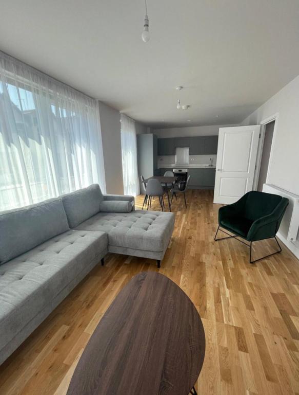 a living room with a couch and a table at VG Apartments 2 Bedroom LDN in London