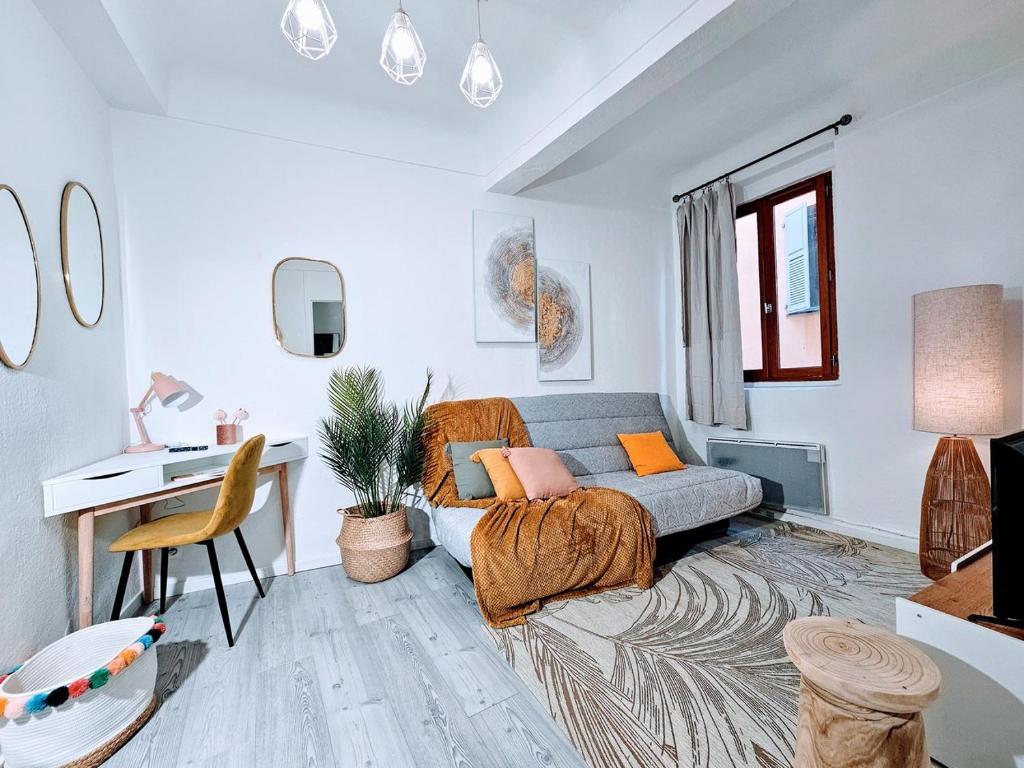 Le Nid Secret Sérénité au Cœur de Grasse في جراس: غرفة معيشة مع أريكة ومكتب