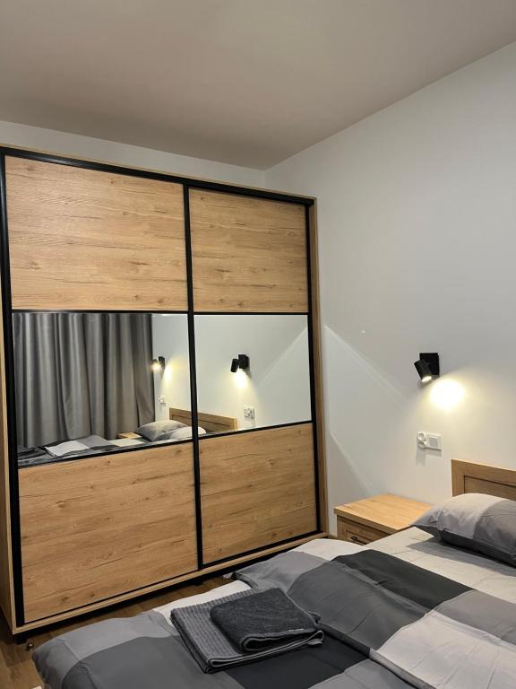 a large bedroom with a large glass wall at Stare Miasto Elbląg Bulvar in Elblag