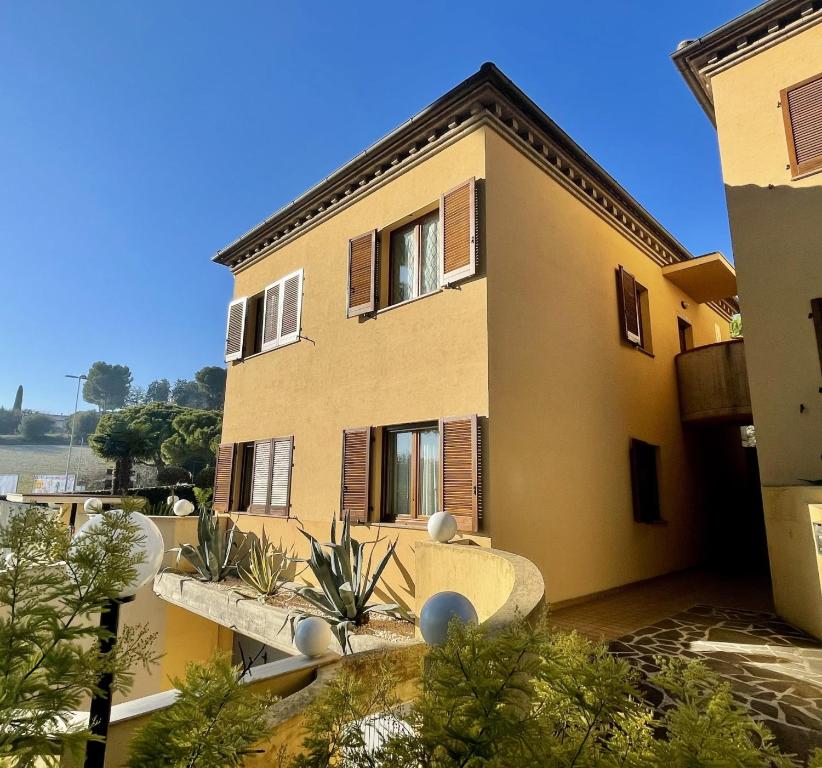 a large building with plants in front of it at Maison Peschiera in Sirolo