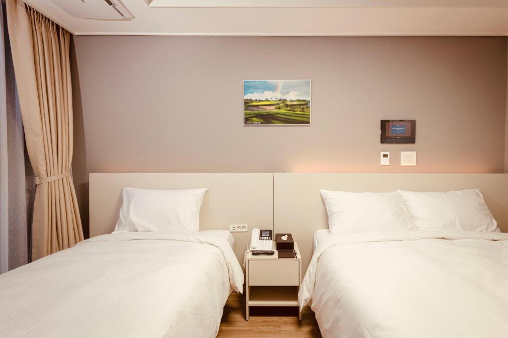 Postel nebo postele na pokoji v ubytování Sollago Myeongdong Hotel & Residence