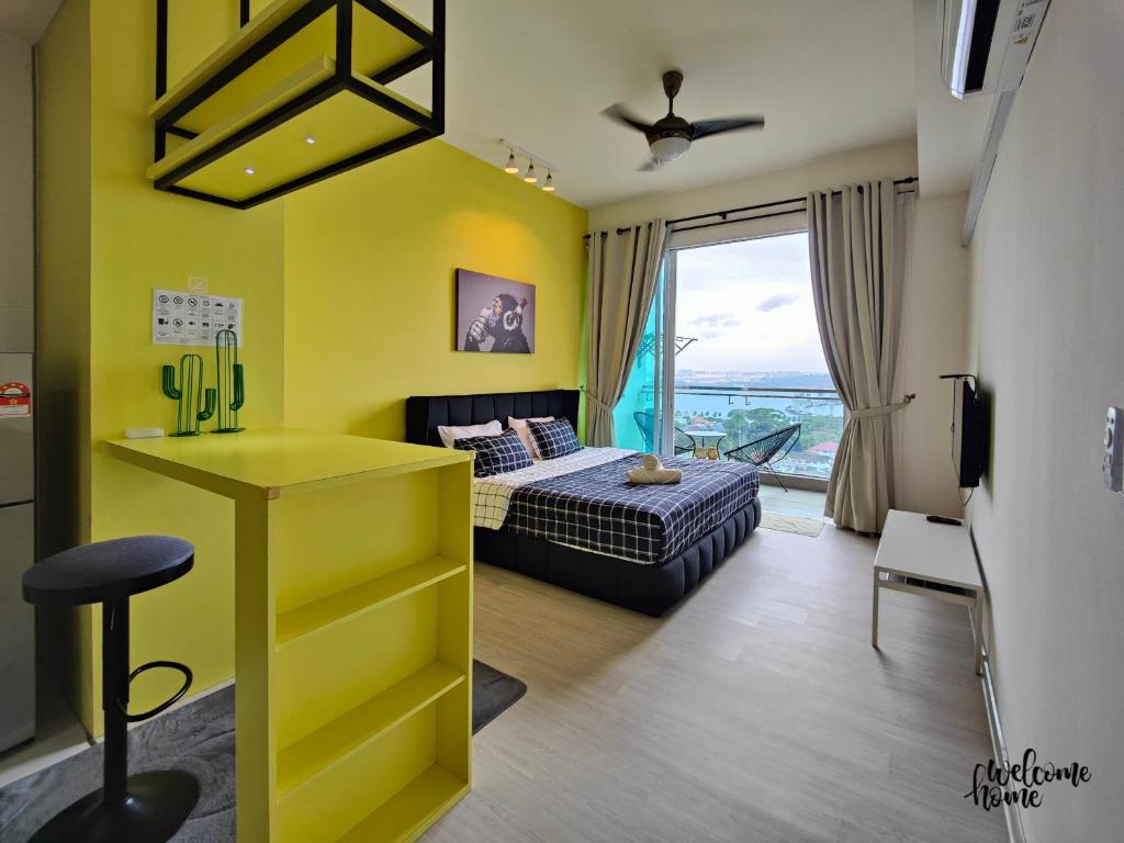 a bedroom with a bed and a yellow wall at Paragon Suites CIQ Homestay by WELCOME HOME in Johor Bahru