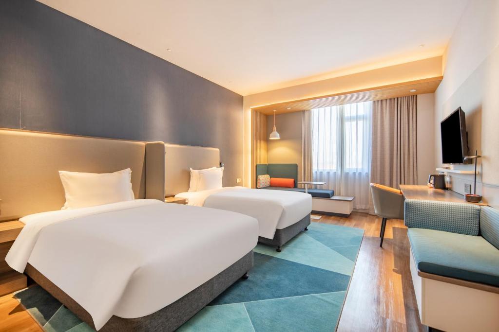 Postel nebo postele na pokoji v ubytování Holiday Inn Express Shanghai Jiading New City by IHG