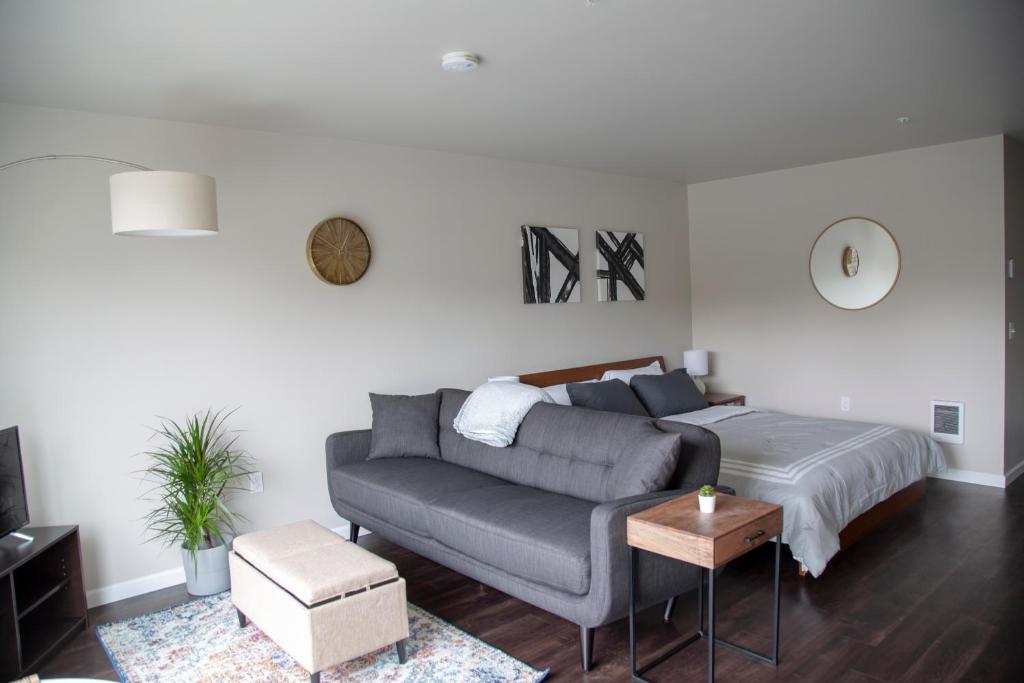 a living room with a couch and a bed at Capitol Hill Modern Studio with Free Parking! in Seattle