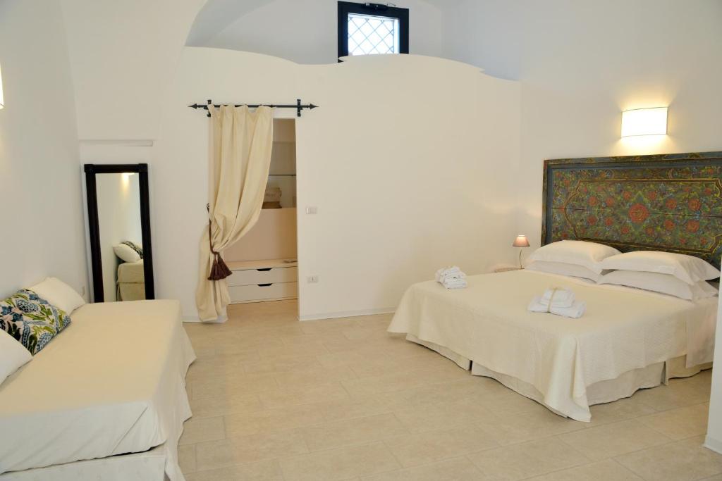 Postel nebo postele na pokoji v ubytování Masseria Palane
