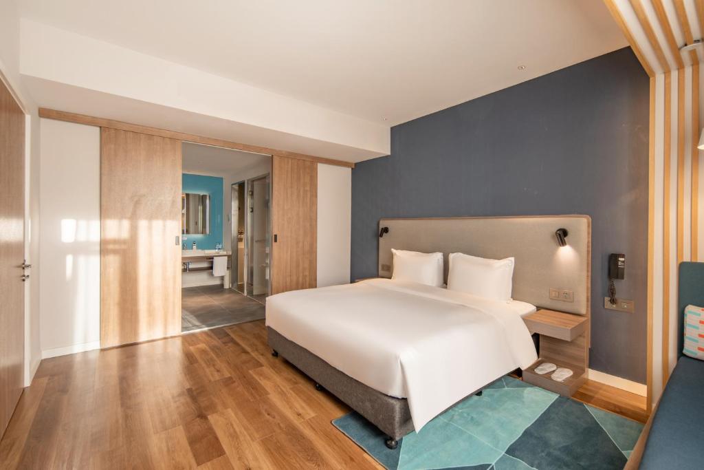 Postel nebo postele na pokoji v ubytování Holiday Inn Express Shanghai Jiading New City by IHG
