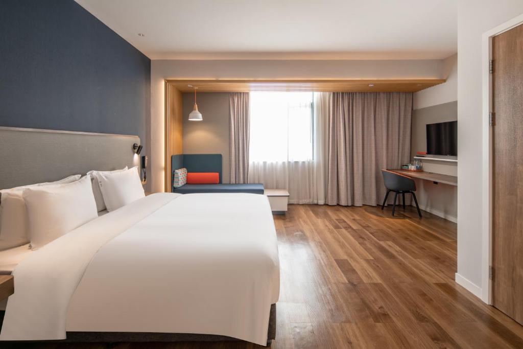 Postel nebo postele na pokoji v ubytování Holiday Inn Express Shanghai Jiading New City by IHG