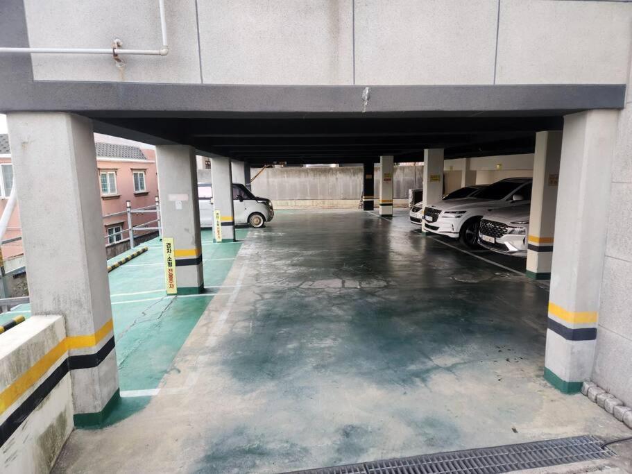 a parking garage with two cars parked in it at Jinistay #Netflix #Oceanview #private barbeque facility #1pm checkout in Ulsan