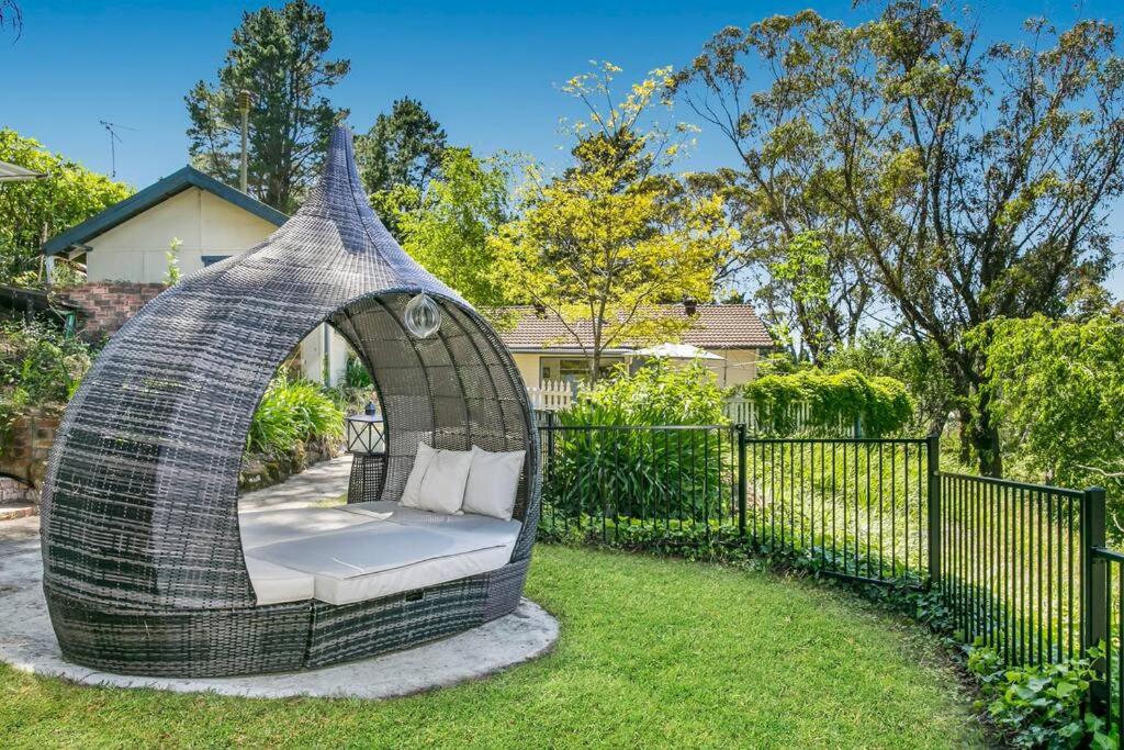 a gazebo in the backyard of a house at Lavender Cottage Leura in Leura
