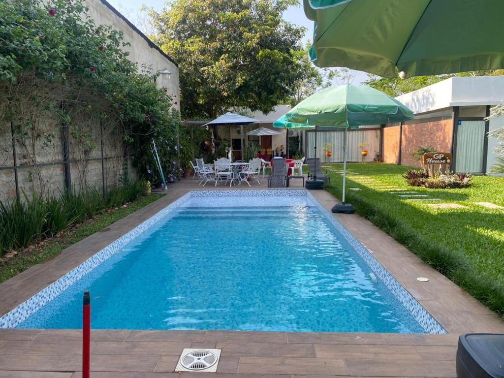 a swimming pool in a yard with an umbrella at GP house’s in San Bernardino