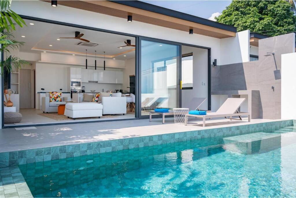 a house with a swimming pool and a living room at Modern Villa Walking Distance to Fisherman Village KBR15 in Amphoe Koksamui
