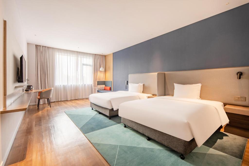 Postel nebo postele na pokoji v ubytování Holiday Inn Express Shanghai Jiading New City by IHG