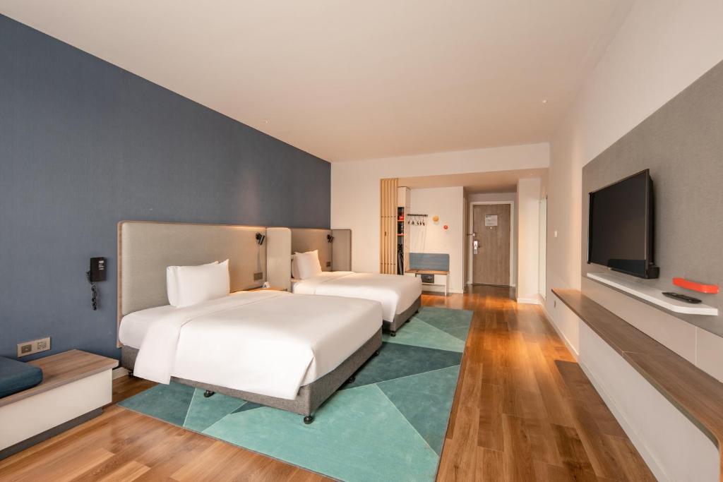 Postel nebo postele na pokoji v ubytování Holiday Inn Express Shanghai Jiading New City by IHG