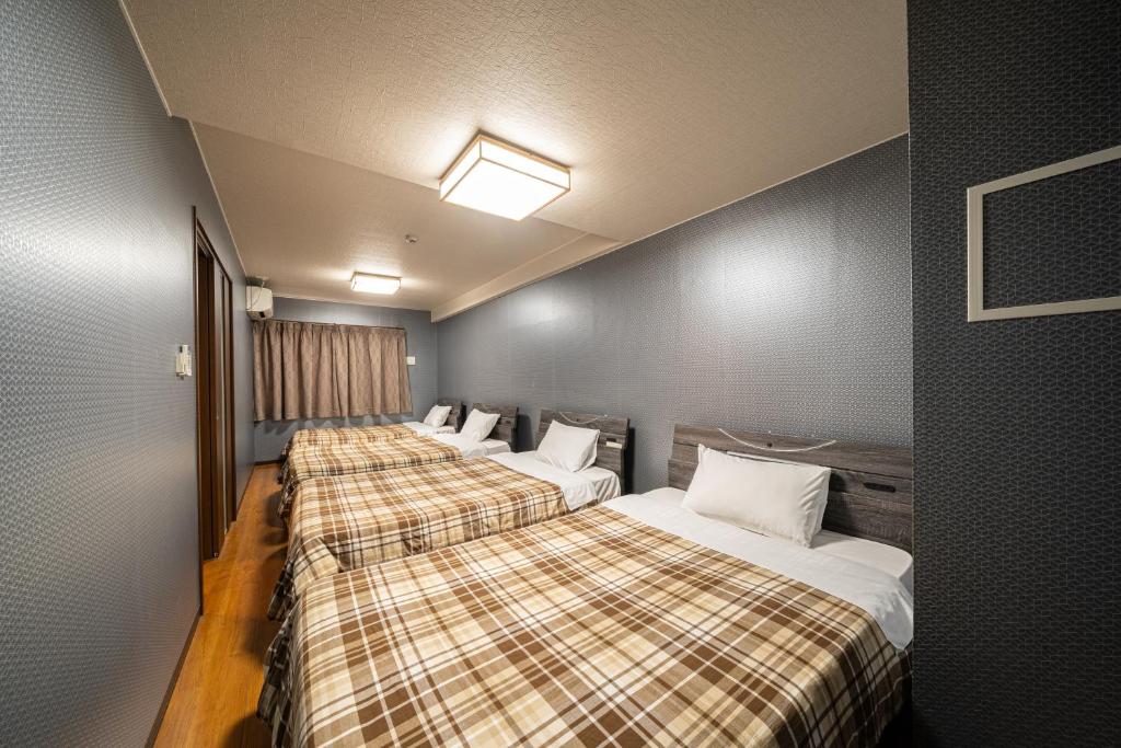 Postel nebo postele na pokoji v ubytování BEPPU HOSTEL U&T