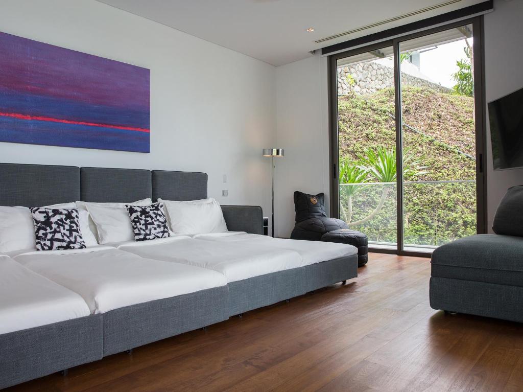 Ein Bett oder Betten in einem Zimmer der Unterkunft Malaiwana Residences