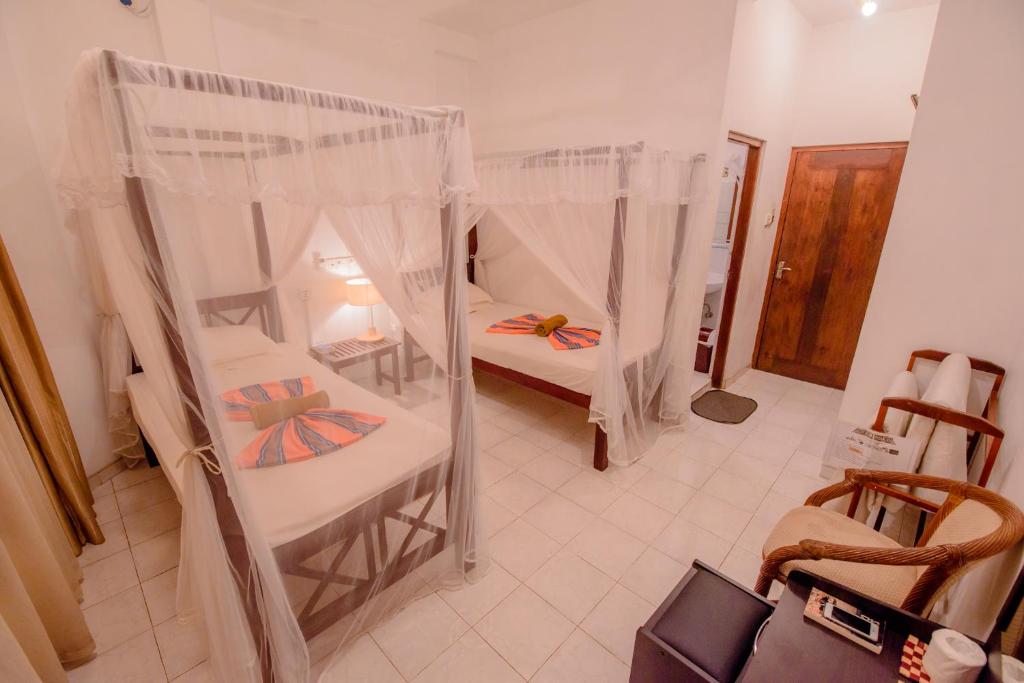 Postel nebo postele na pokoji v ubytování Muhsin Villa - Galle Fort