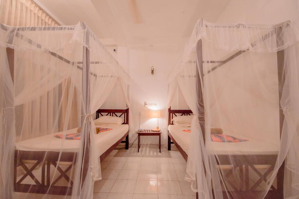 Postel nebo postele na pokoji v ubytování Muhsin Villa - Galle Fort