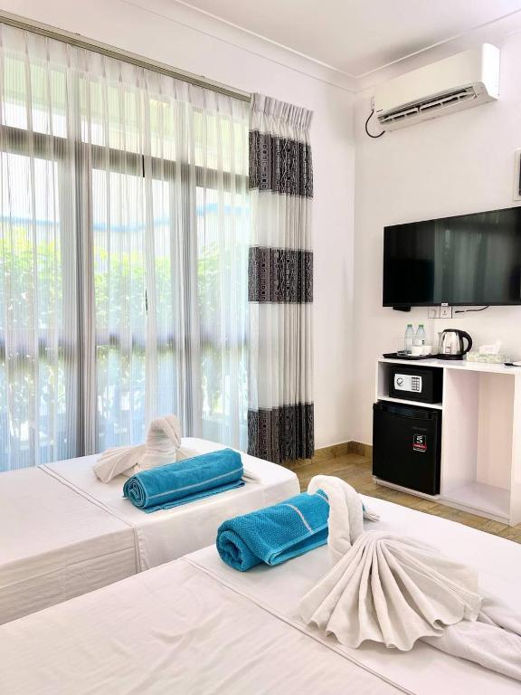 Postel nebo postele na pokoji v ubytování Balma Beach Inn