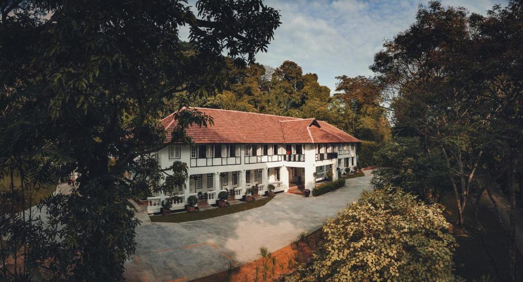 un grand bâtiment blanc avec un toit rouge dans l'établissement Labrador Villa, à Singapour