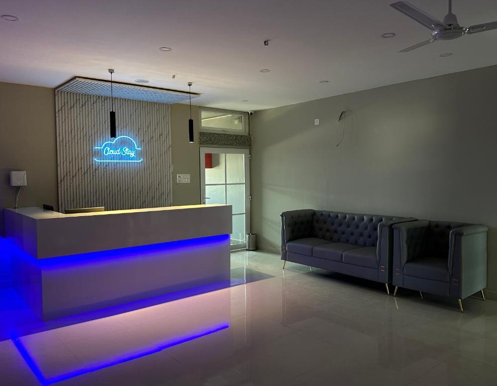 a lobby with a couch and a reception desk at Cloud Stay in Guwahati