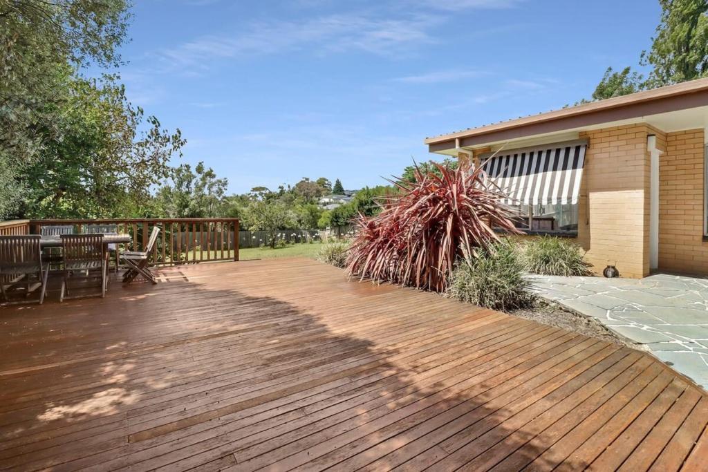 a wooden deck in front of a house at Scenic Serenity Large Family Home in Geelong in Geelong