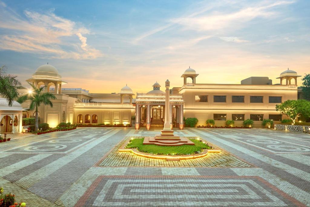 a building with a fountain in the middle of a courtyard at Heritage Village Resort & Spa Manesar-Gurgaon in Gurgaon