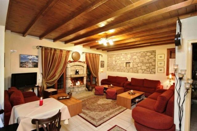 salon z kanapą i kominkiem w obiekcie Koustenis Village w mieście Dimitsana