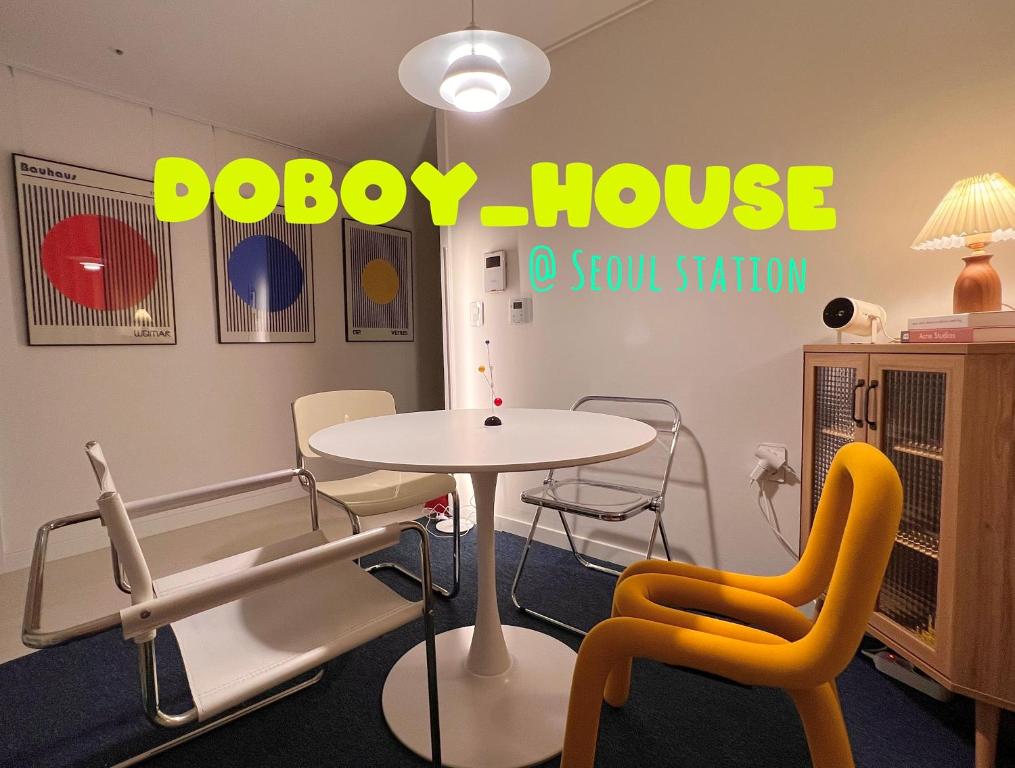 首爾的住宿－DOBOY House，配有桌椅和圆顶房屋标志的客房