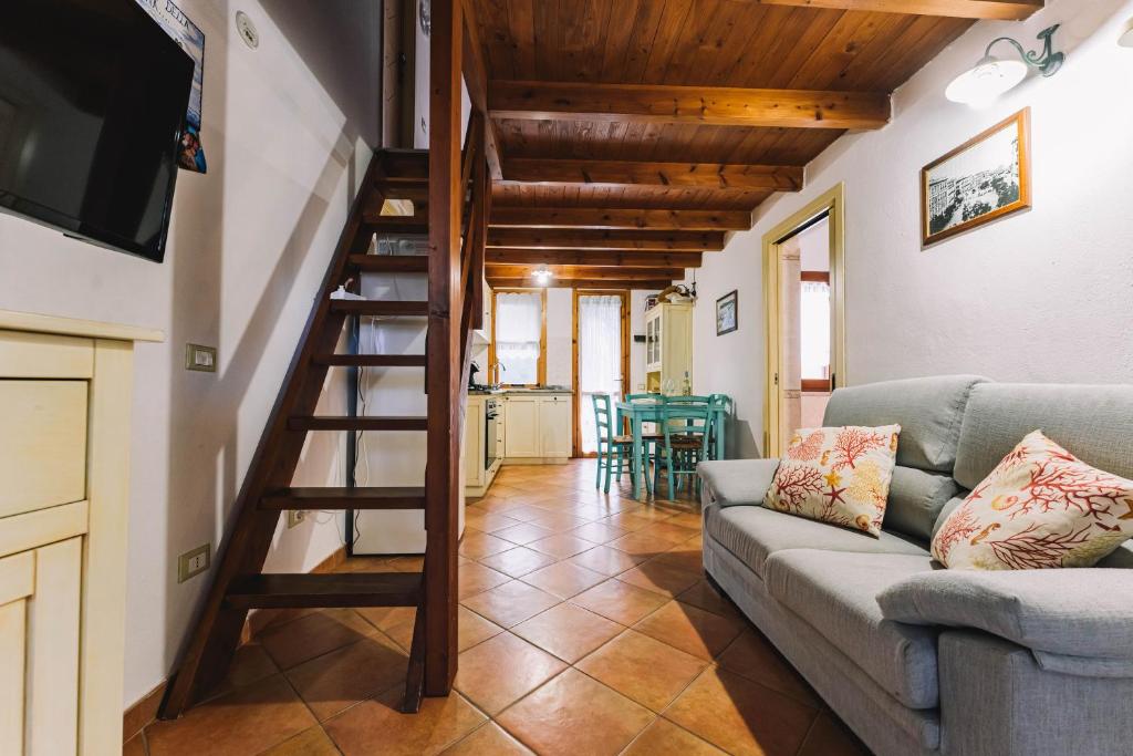 salon ze schodami i kanapą w obiekcie Oasi del Relax w mieście Costa Rei