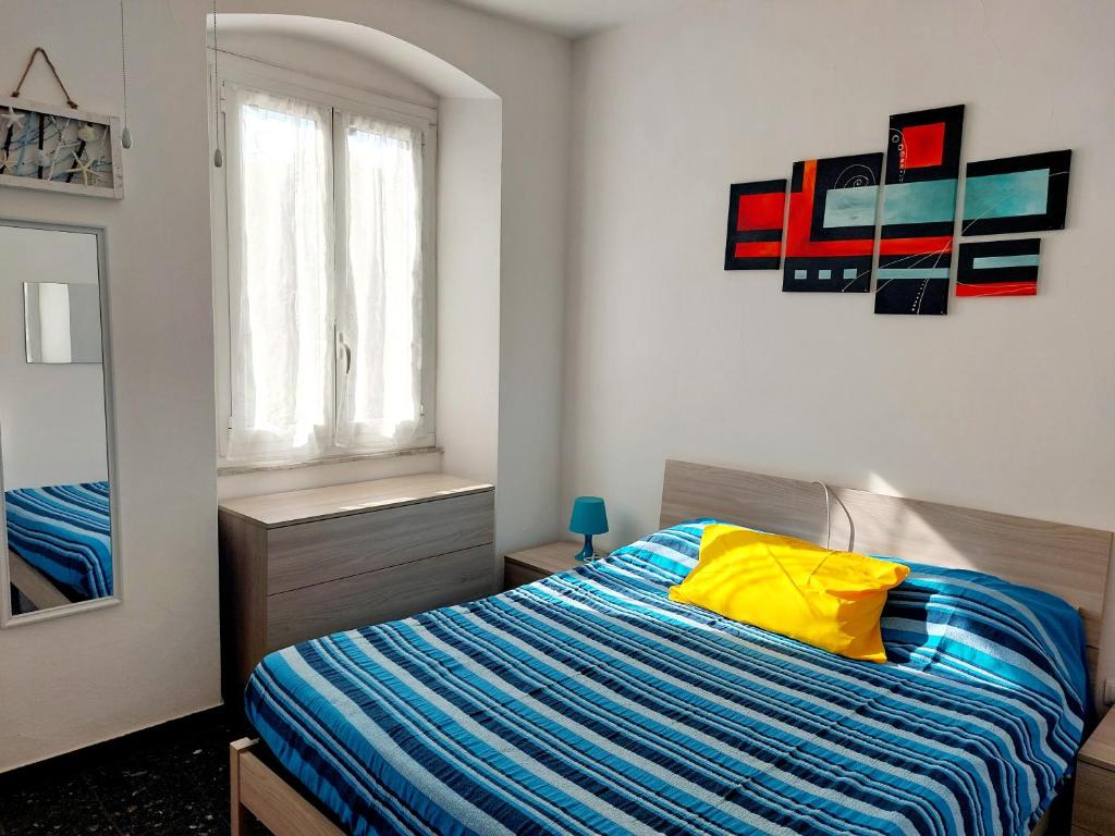 a bedroom with a bed with a yellow pillow at Dal Pontevecchio House in Casarza Ligure