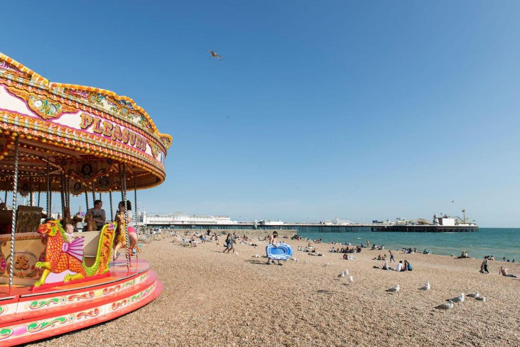 a carnival ride on a beach with a crowd of people at Maldron Hotel Brighton City Centre in Brighton & Hove