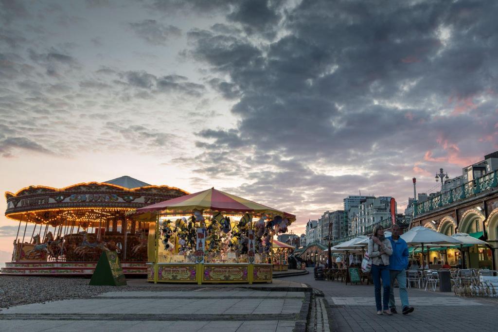a group of people walking around a market with a carousel at Maldron Hotel Brighton City Centre in Brighton & Hove