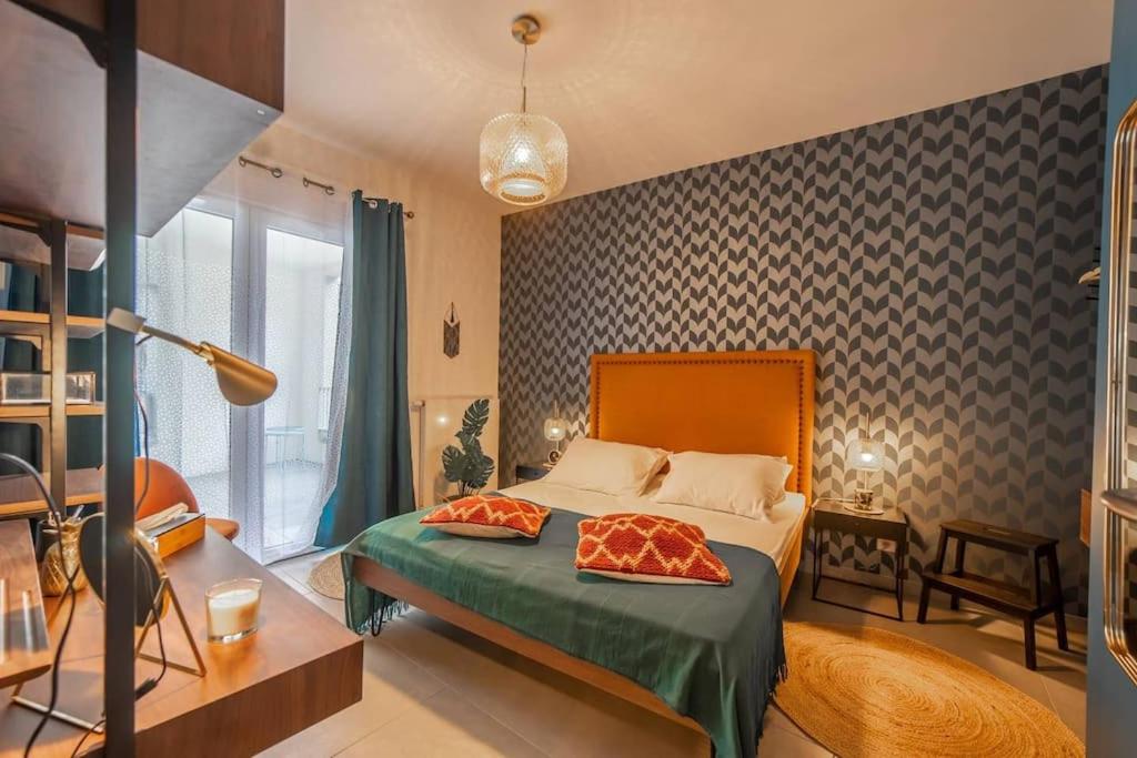 a bedroom with a bed with two pillows on it at Honey - confort, proche lac avec garage in Annecy
