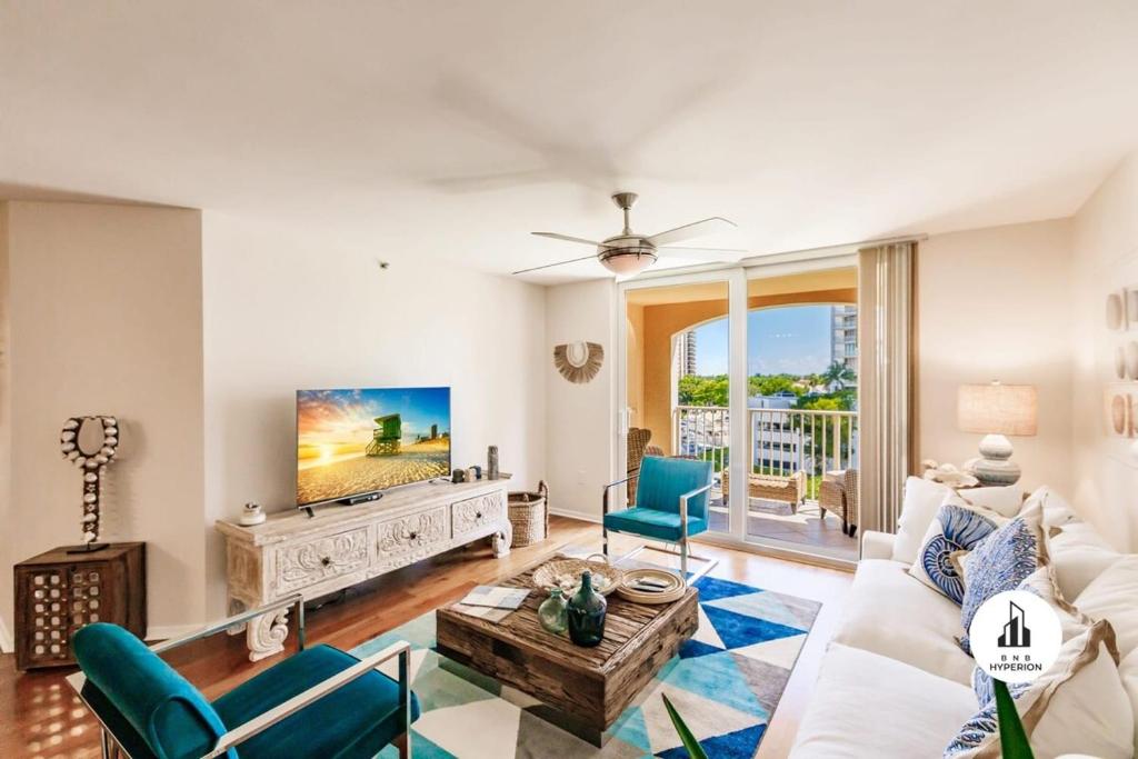 - un salon avec un canapé blanc et une télévision dans l'établissement Bnb Hyperion - 3BR Condo w Pool, Hot Tub, Golf, GYM, à Miami
