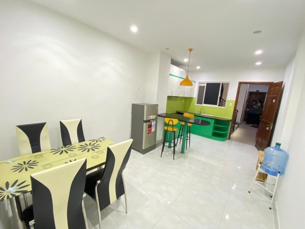 a kitchen and dining room with a table and chairs at Happy House in Ho Chi Minh City