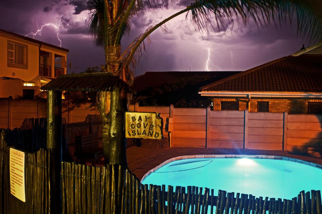 a lightning storm over a house with a swimming pool at Bay Cove Inn in Jeffreys Bay