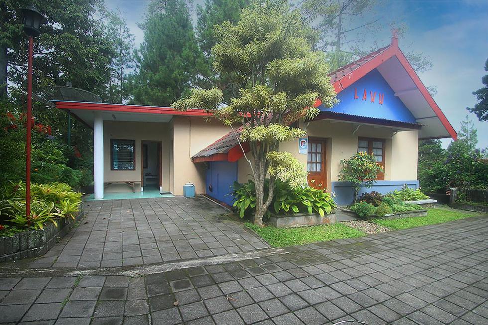 a small house with a tree in front of it at Hotel Villa Rawa Pening Pratama by Aparian in Bandungan