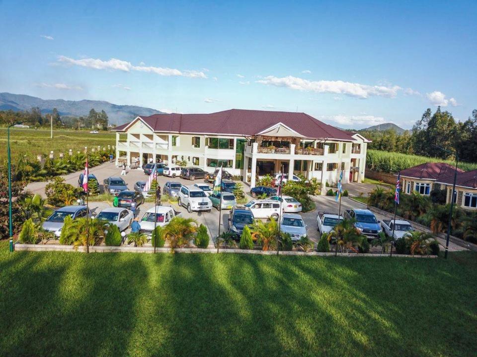 an aerial view of a hotel with a parking lot at Koru Country Club in Muhoroni