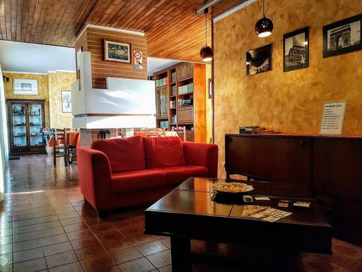 a living room with a red couch and a table at Casa Riccio in Palermo