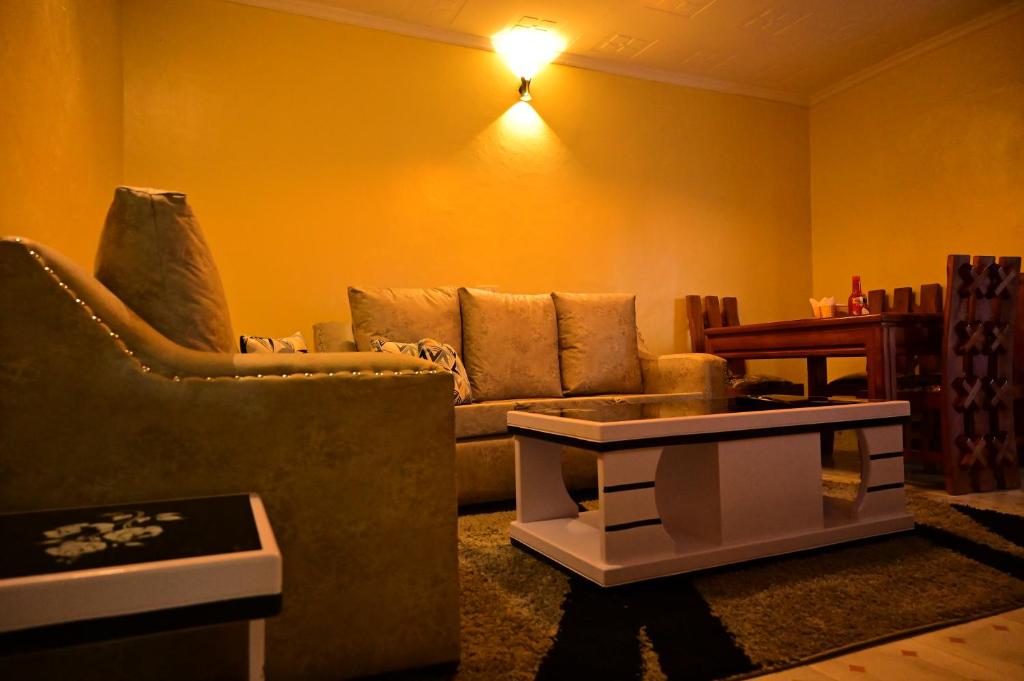 a living room with a couch and a coffee table at THE PINGS BNB in Narok