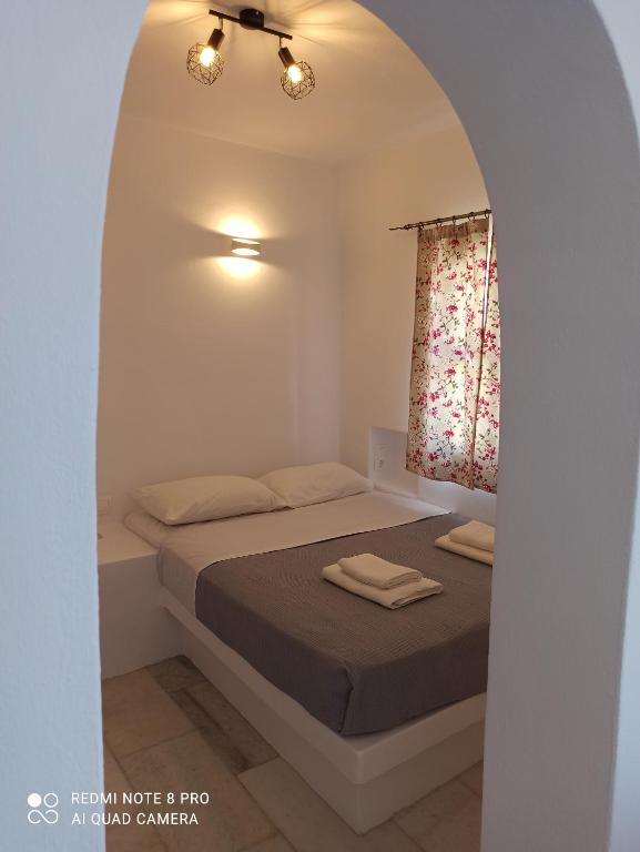 a bedroom with a bed in a white room at Vlastos 2 in Mylopotas