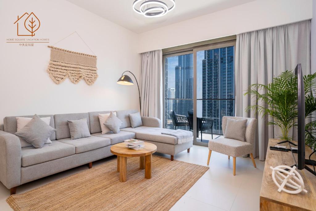 a living room with a couch and a table at Family Apartment with Burj Views at Top Floor 175BC-3 in Dubai