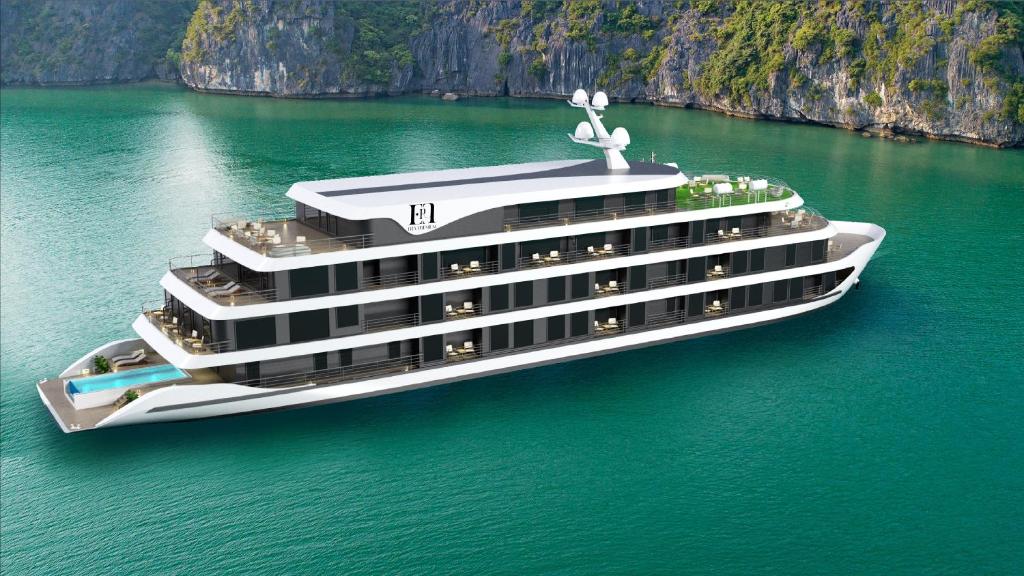 a cruise ship in the water next to a cliff at Era Cruises Halong in Ha Long