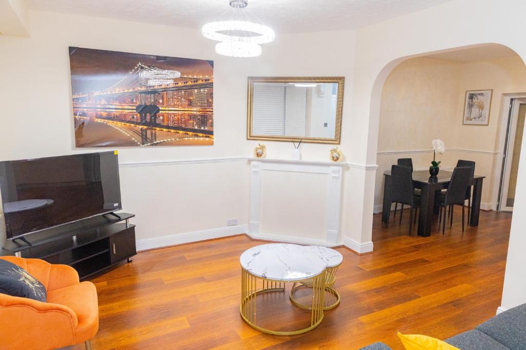 a living room with a couch and a tv at Fortune 24 house in Rainham