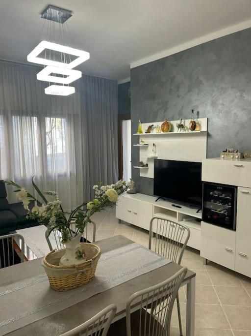 a kitchen with a table with chairs and a dining room at Casa di Fati in Mestre