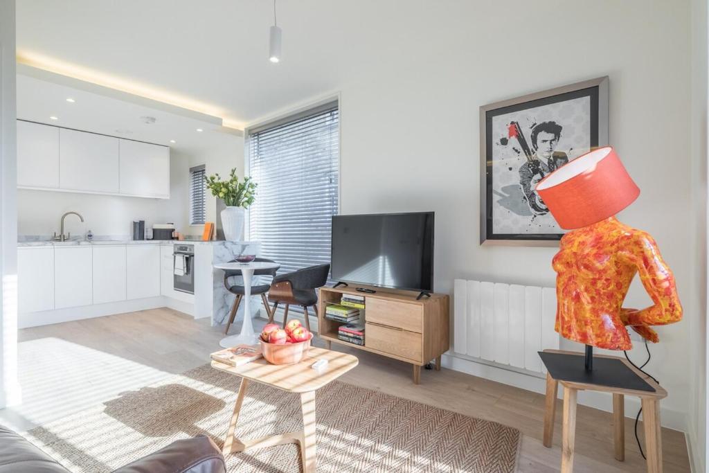 a living room with a mannequin standing on a chair at Luxury Central Riverside Apartment in Cambridge