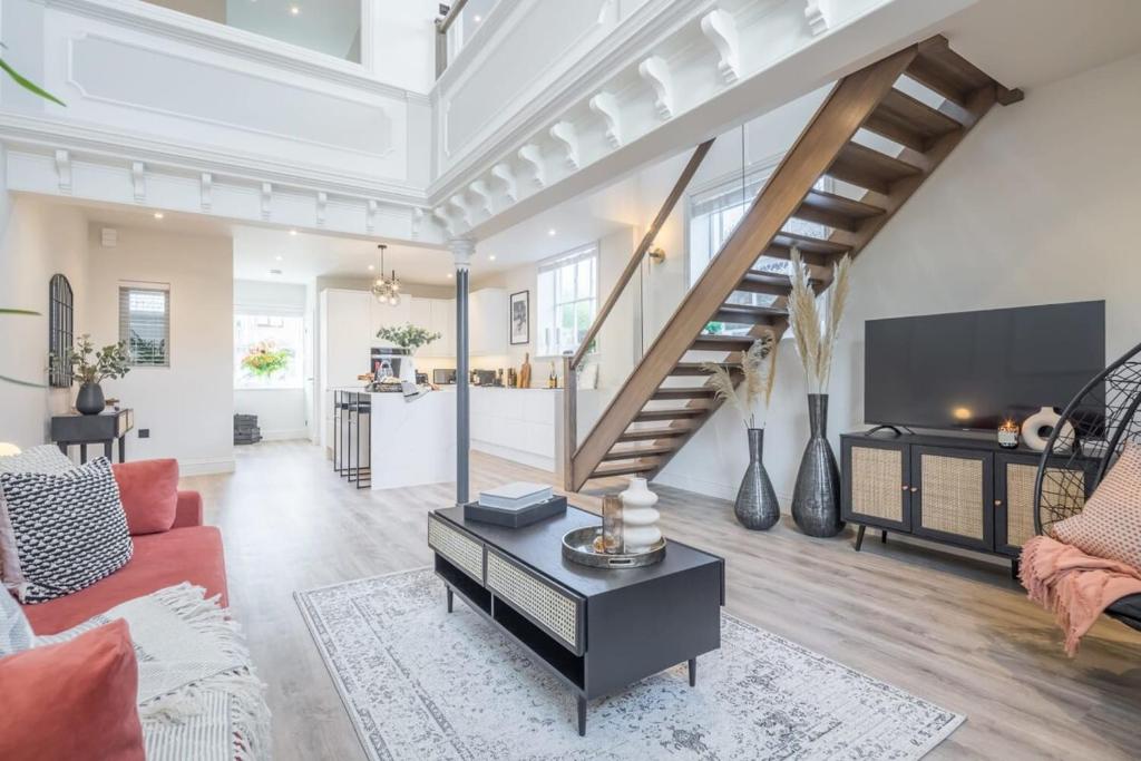 a living room with a staircase and a living room at Deluxe Modern-themed 1 Bedroom Apartment in Cambridge