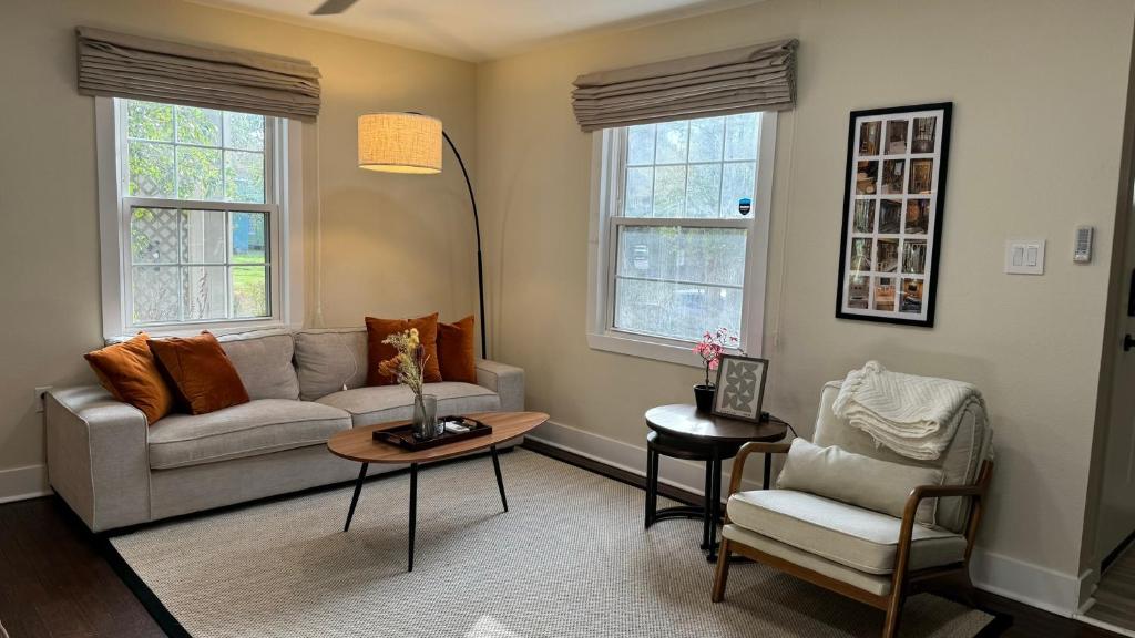 a living room with a couch and a table and two chairs at Garden District Duplex in Baton Rouge