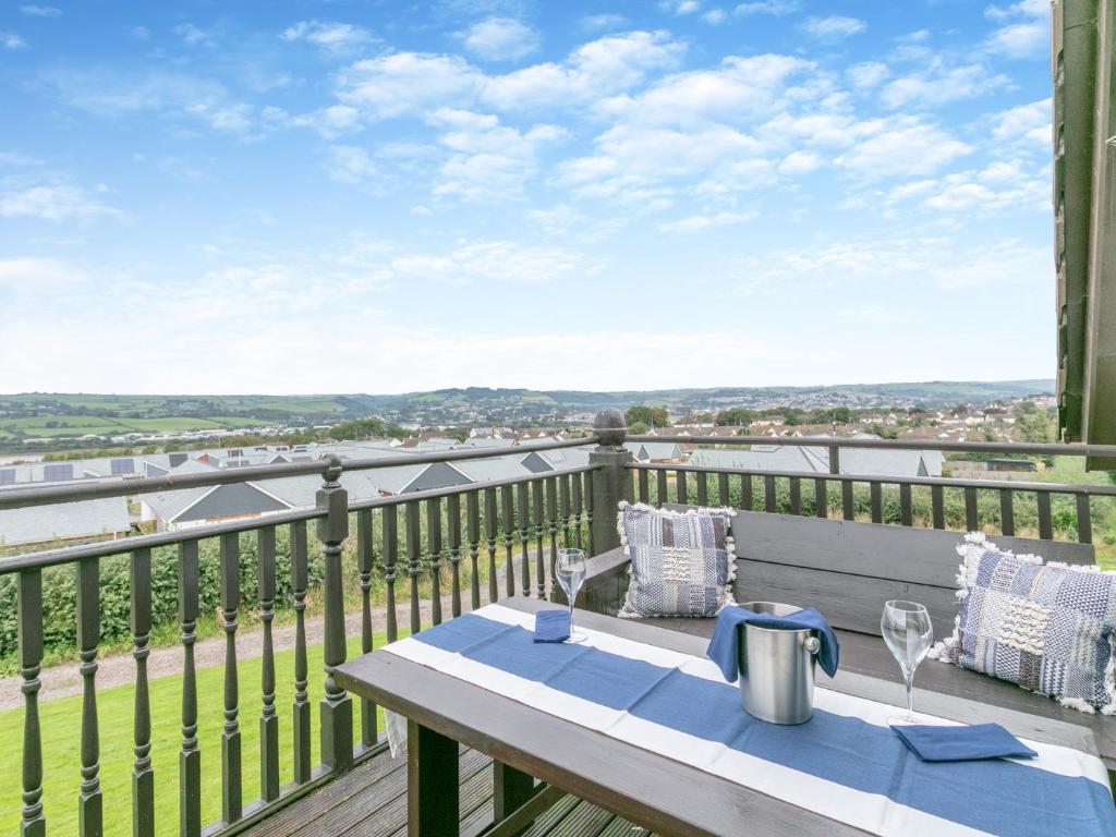a table on a balcony with a view of the water at 4 Bed in Barnstaple ELLER in Fremington
